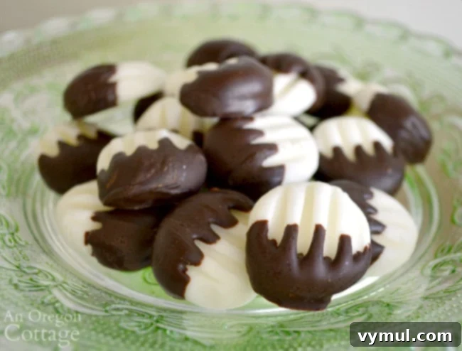 Close-up view of dark chocolate cream cheese mints, showcasing the smooth chocolate coating and creamy mint interior. A perfect homemade dessert for any occasion.