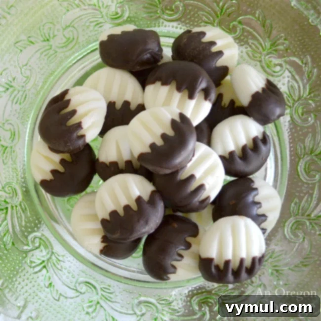 Aerial view of dark chocolate cream cheese mints on a parchment-lined tray, freshly made and ready to be enjoyed or carefully packaged.