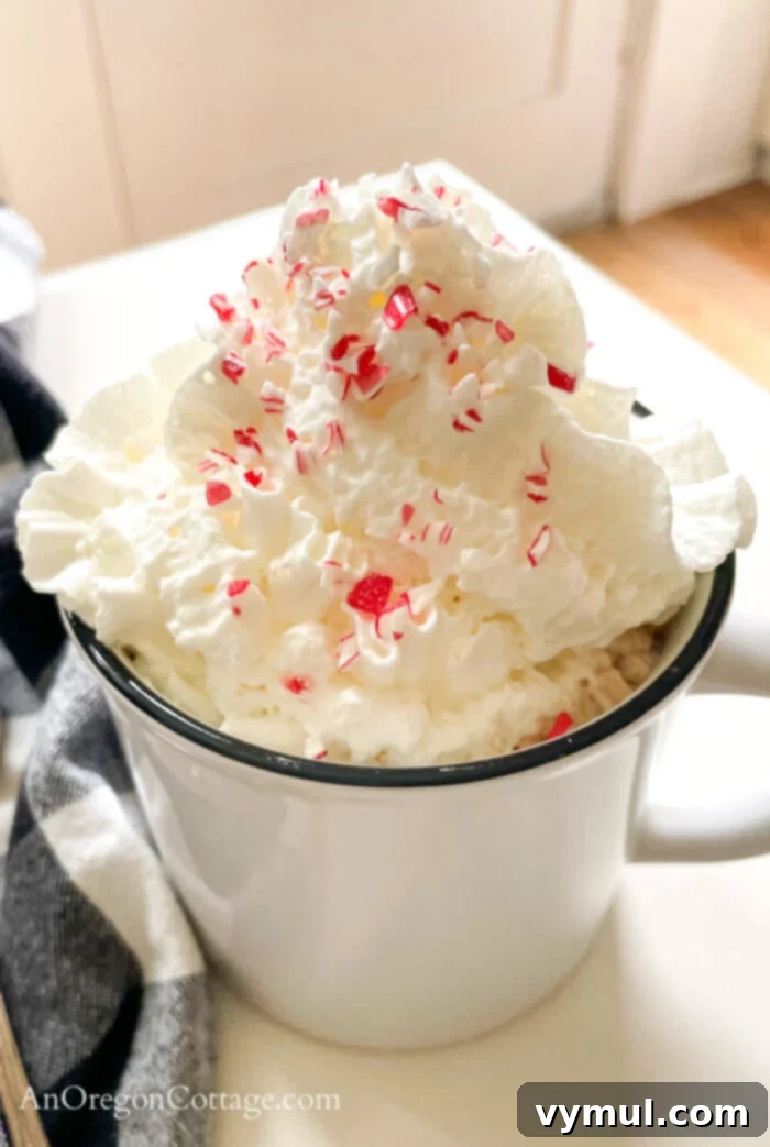 Effortless Peppermint Mochas: Giftable & Healthier Homemade Delights 5 A festive peppermint mocha in a white mug, topped with whipped cream and a sprinkle of crushed candy canes, ready to be enjoyed.