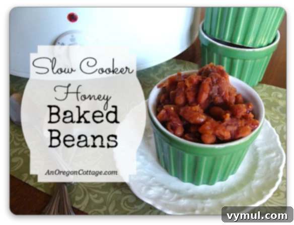 Slow Cooker Honey Baked Beans - A comforting and easy homemade side dish recipe from An Oregon Cottage.