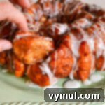 pulling a piece of monkey bread from loaf