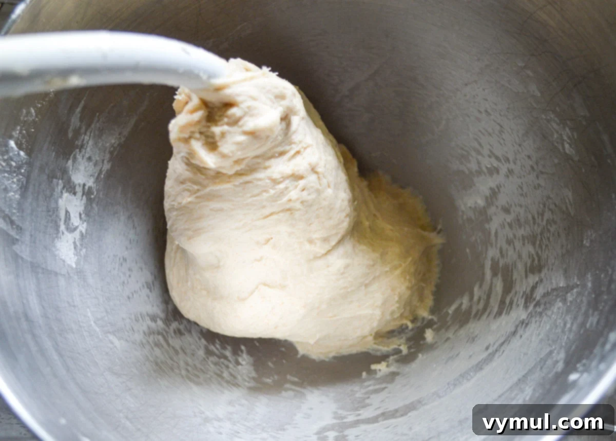monkey bread dough after kneading in mixer bowl, looking smooth and elastic