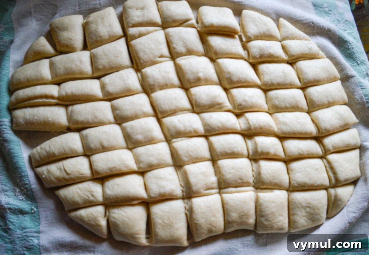 monkey bread dough cut into small pieces on a floured surface