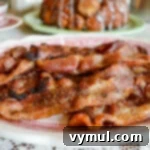 cooked coated bacon on plate on a table