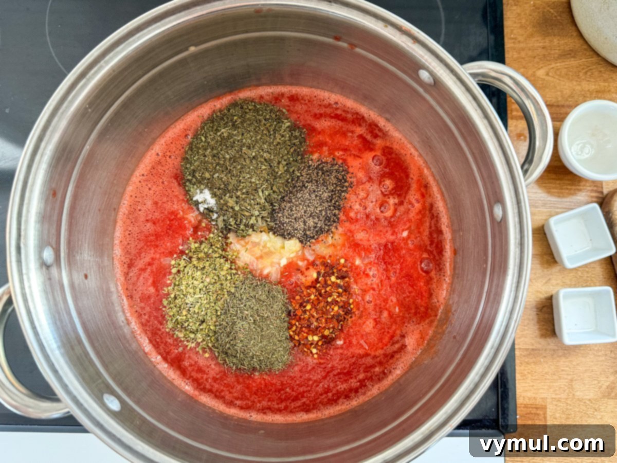 Simple Homemade Pizza Sauce for Canning Fresh or Frozen Tomatoes 8 add spices to tomato puree in stockpot