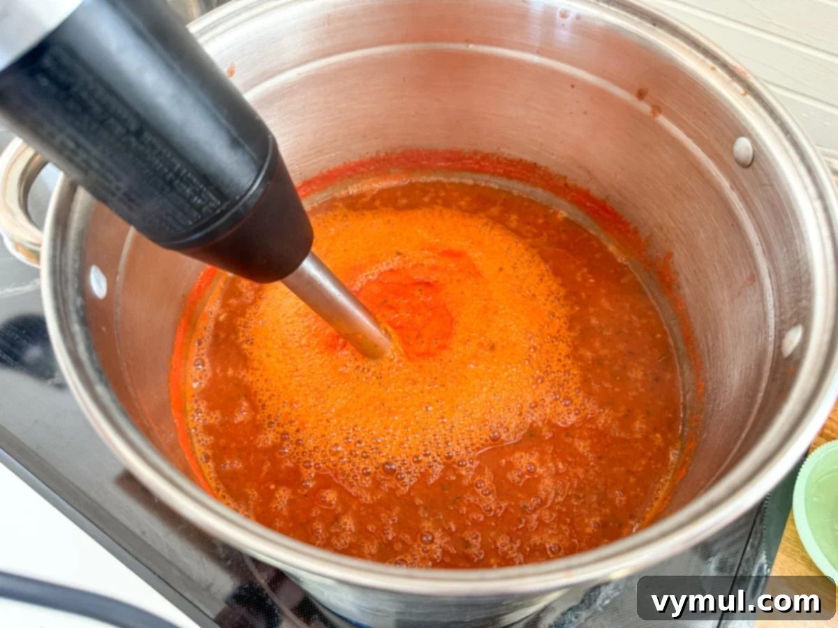 Simple Homemade Pizza Sauce for Canning Fresh or Frozen Tomatoes 9 using stick blender in stockpot for smooth sauce