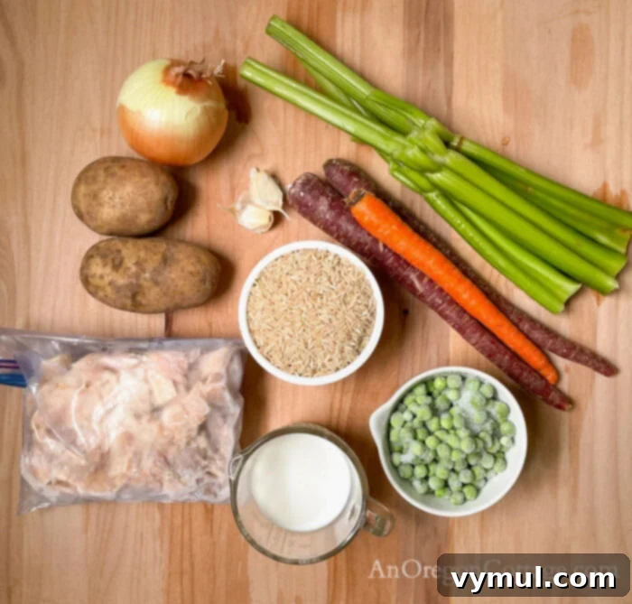 Effortless Creamy Turkey and Chicken Rice Soup 4 creamy turkey rice soup ingredients laid out, including turkey, vegetables, broth, and rice