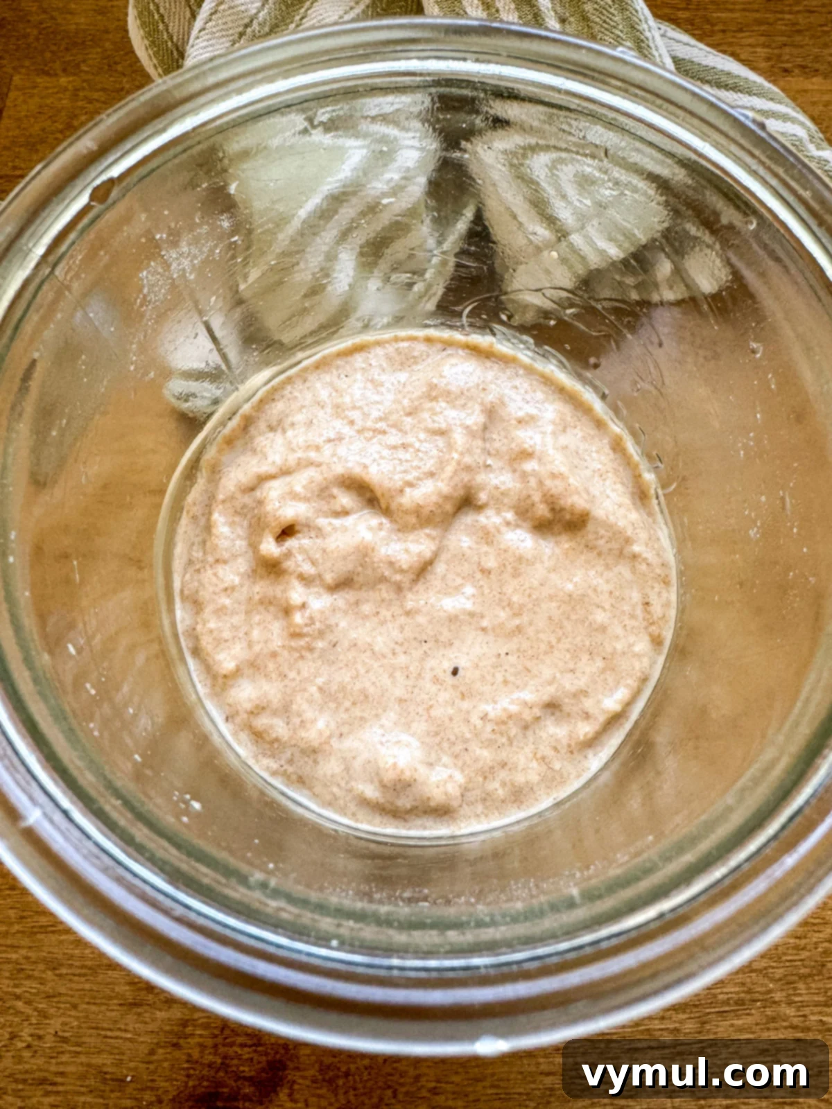 Easy Sourdough Starter Recipe to Grow, Keep, and Use 3 Freshly fed sourdough starter, actively bubbling in a glass jar, demonstrating health and readiness for use.