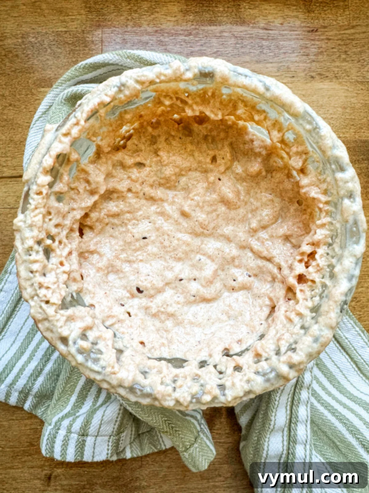 Easy Sourdough Starter Recipe to Grow, Keep, and Use 7 Top-down view of a highly active and bubbly sourdough starter in a glass jar, demonstrating readiness for use.
