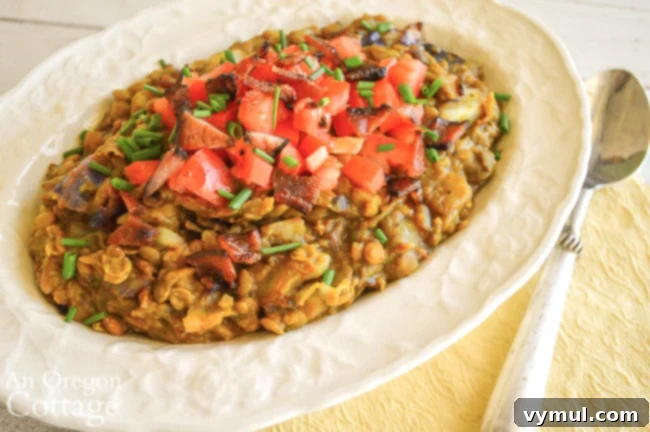 Bacon Lentil Curry with Golden Cabbage 3 A close-up shot of the rich, savory curried lentils with a topping of diced fresh tomatoes, highlighting the vibrant colors and appealing texture of the dish.