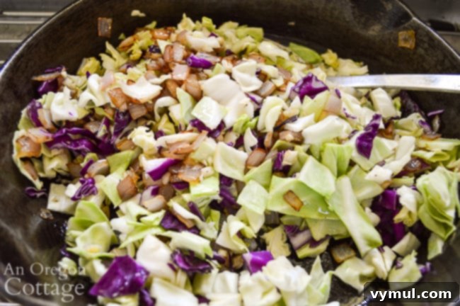Bacon Lentil Curry with Golden Cabbage 6 Chopped cabbage and onions sautéing in a skillet, creating a rich, browned base for the lentil dish.