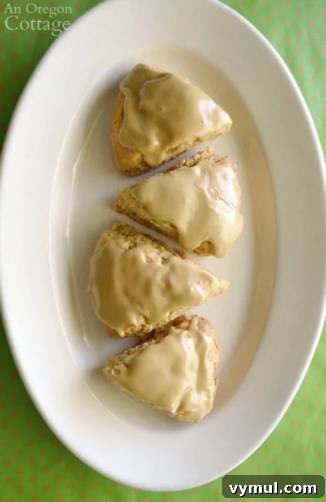 Top-down view of freshly baked Maple Oat Scones with glaze