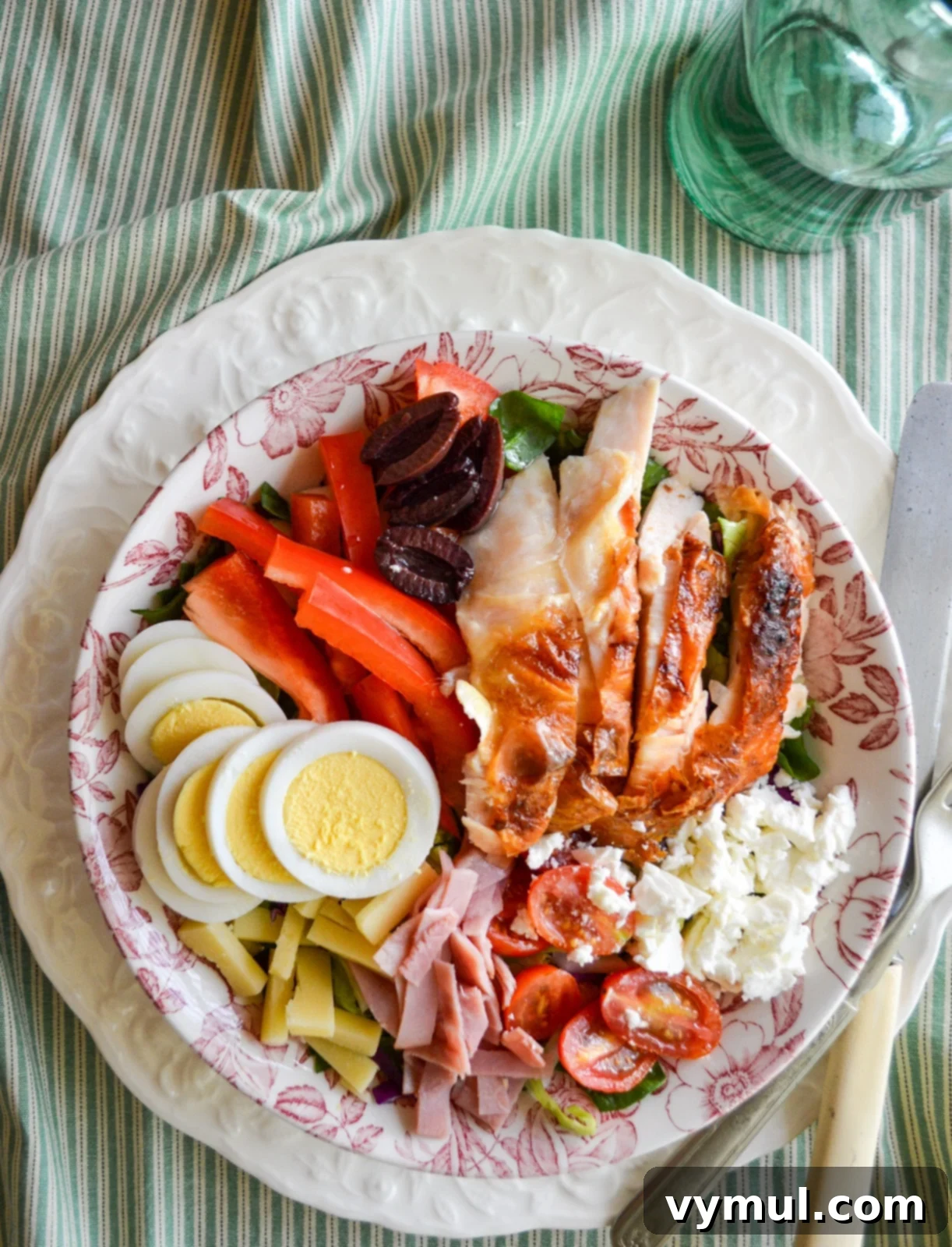 Simple Speedy Chefs Salad 2 A vibrant bowl of prepared chef's salad, overflowing with fresh greens, meats, cheeses, and vegetables, ready to be enjoyed.