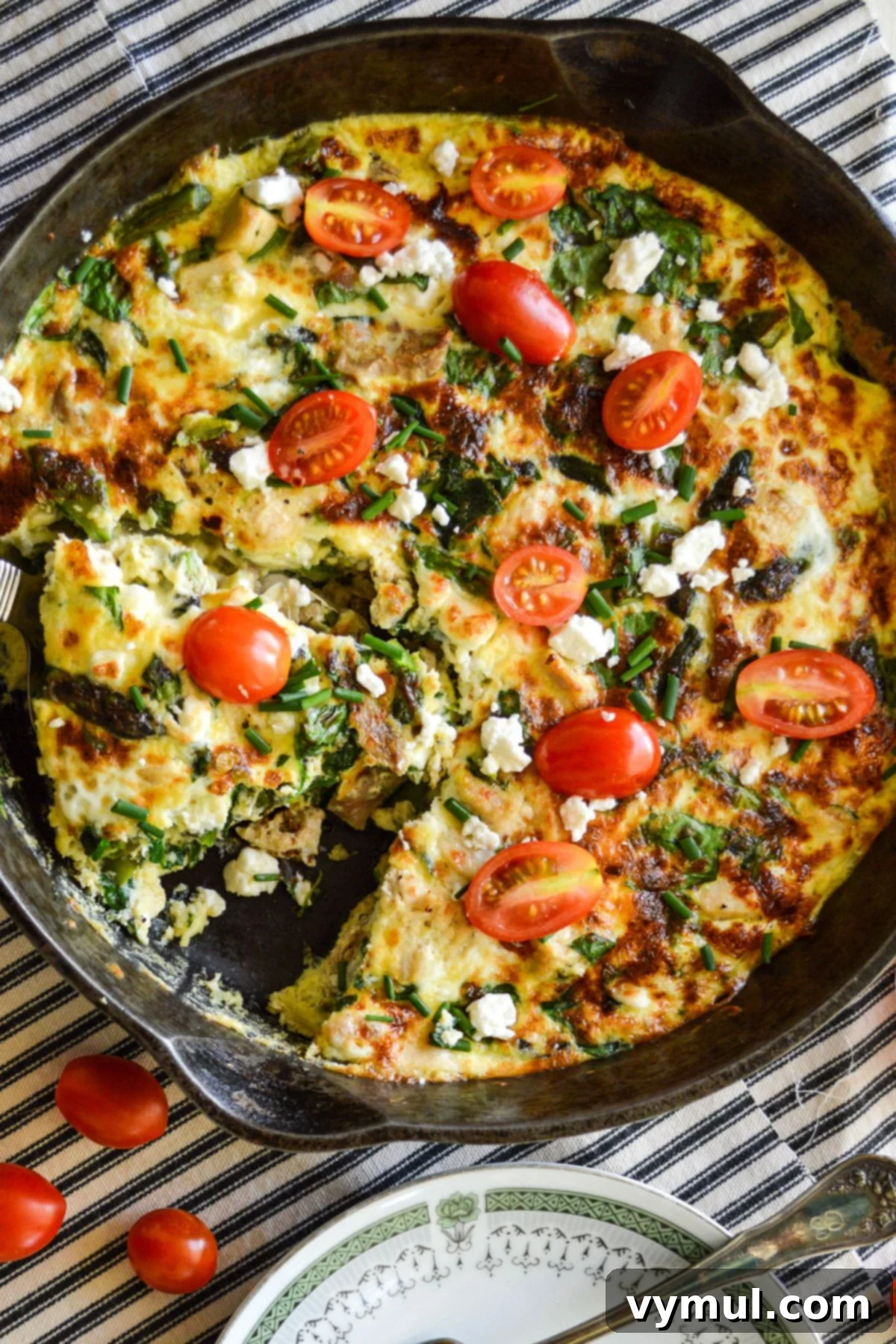 chicken and spinach frittata in cast iron pan above
