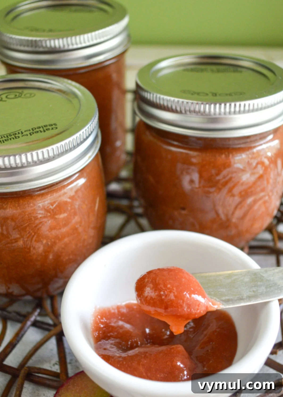 Effortless Three-Ingredient Rhubarb Honey Lemon Butter 3 rhubarb butter on knife with jars in background