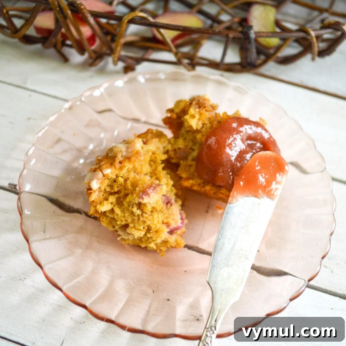 Effortless Three-Ingredient Rhubarb Honey Lemon Butter 7 spreading rhubarb butter on a muffin