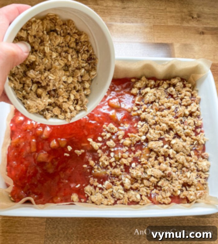 adding crumb topping to rhubarb bars