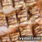 Grain Free Gluten Free Almond Coconut Bliss Bars 7 almond coconut bars with chocolate drizzle cut into pieces