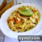 A vibrant bowl of Spicy Cumin-Lime Slaw, ready to serve as a refreshing side dish or taco topping.