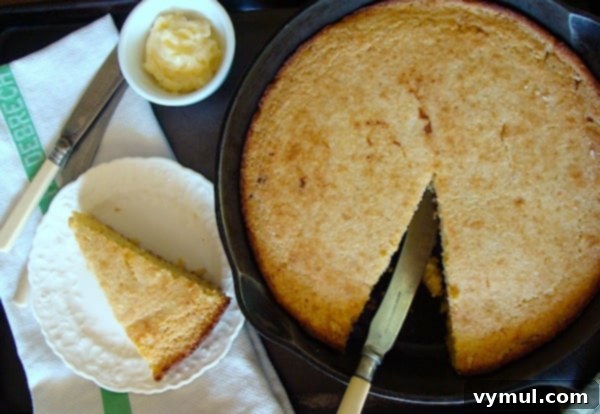 Rich, golden-brown Cornbread in a cast iron skillet, freshly baked and ready to serve, a perfect side for fall soups and stews.