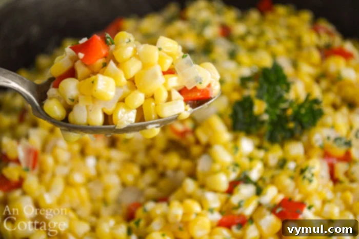 A spoonful of vibrant Corn, Pepper, and Onion Sauté, ready to be enjoyed.