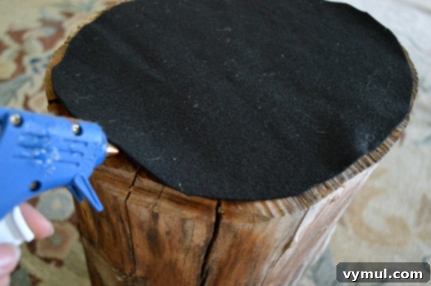 Hot glue felt to bottom of a wood stump to make an easy DIY side table! An Oregon Cottage