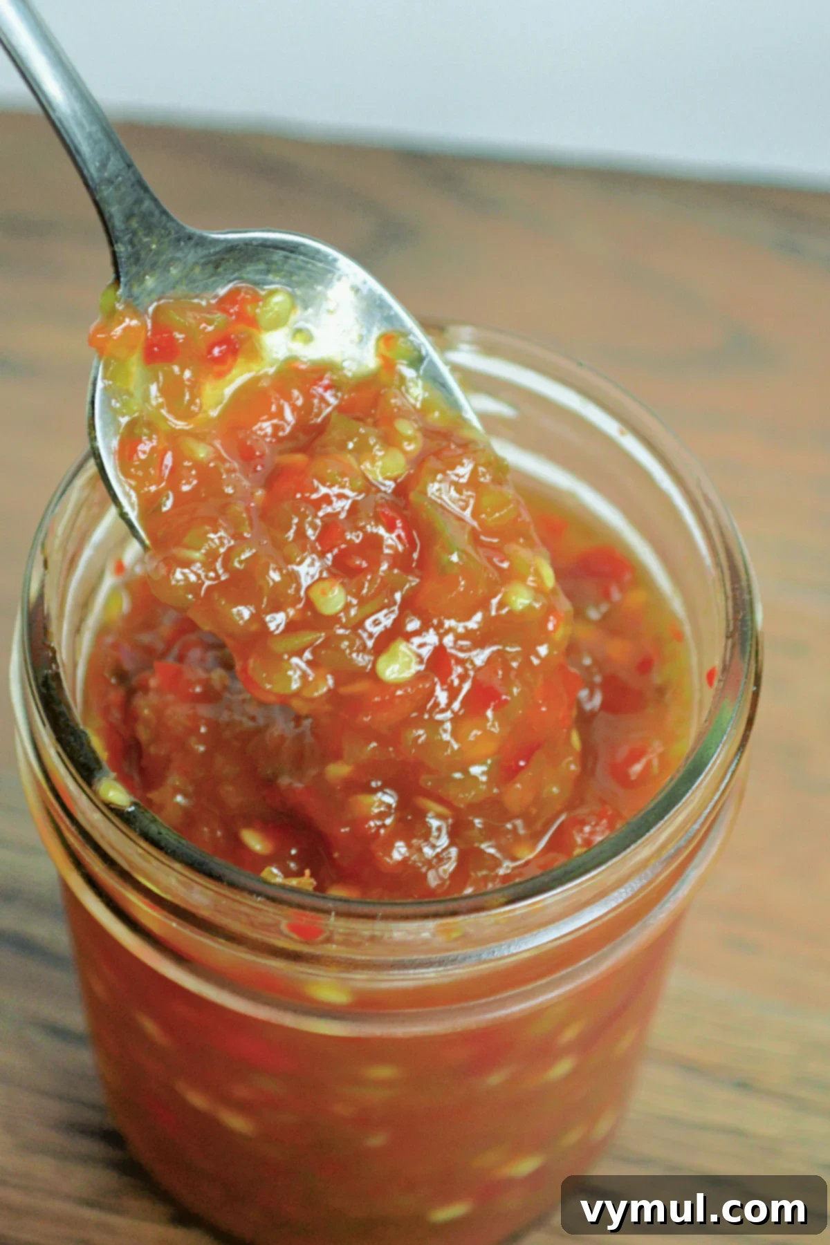 pepper jelly on spoon in jar