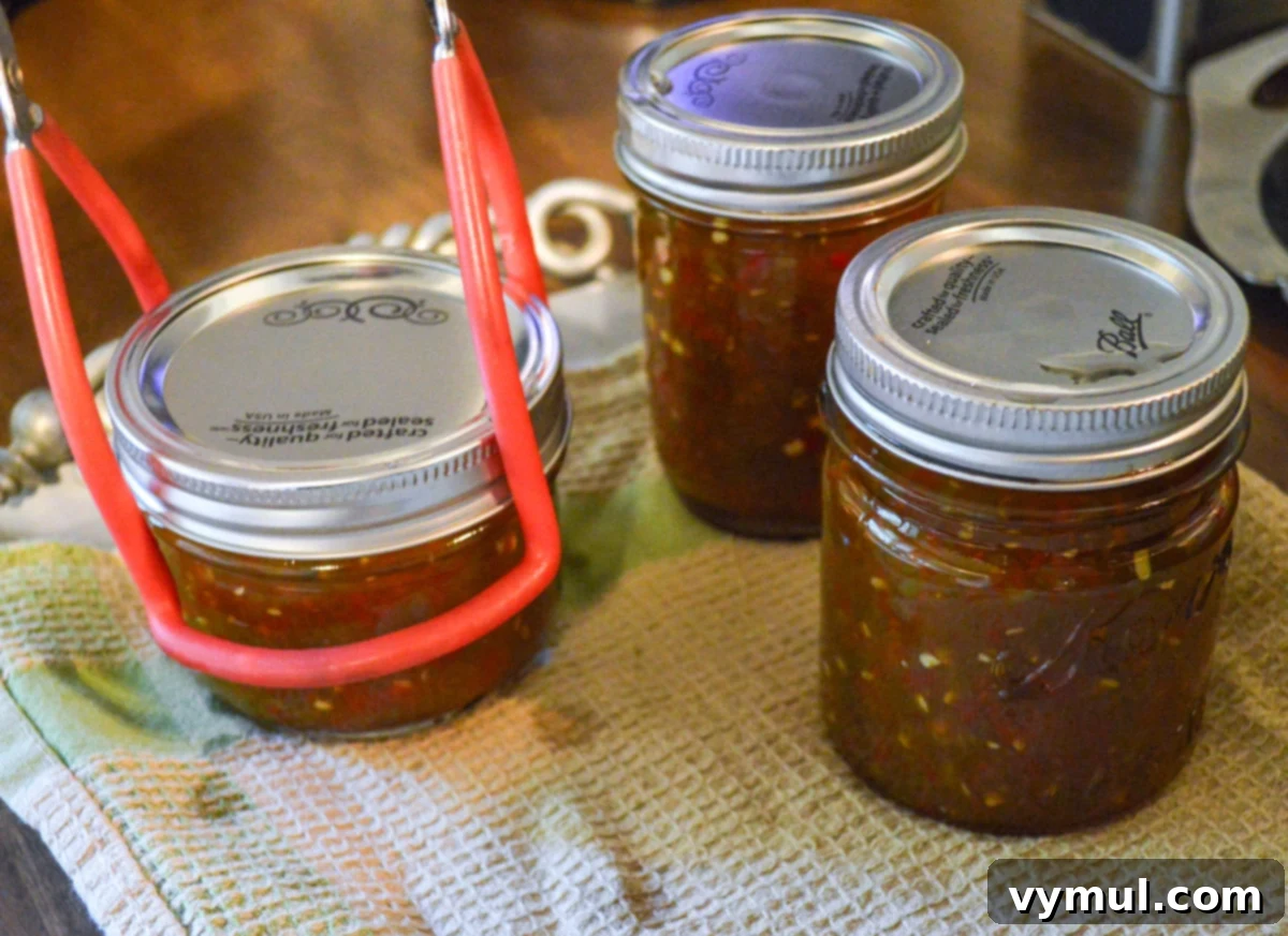 transferring jars from canner to towel lined tray