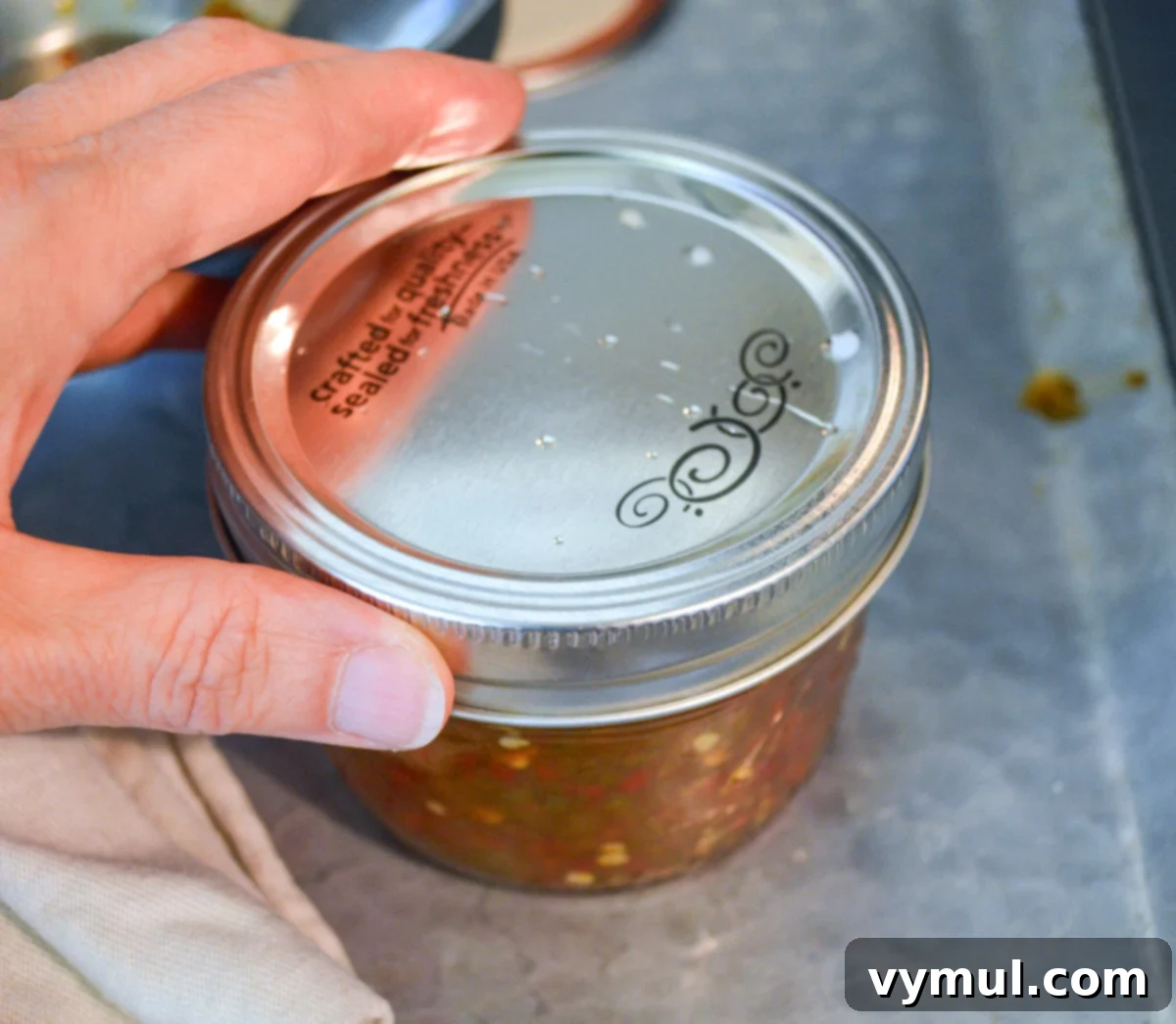 attaching lid to canning jar
