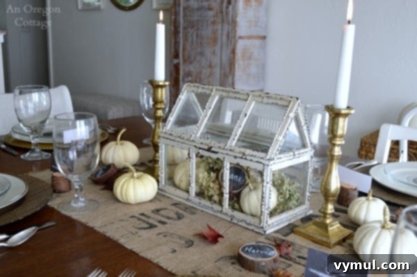 Rustic and gold Thanksgiving table centerpiece with natural elements and candles