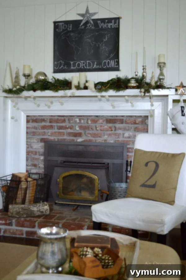 A Cozy Cottage Christmas 2014 11 Joy To The World map Christmas mantel with natural greenery and rustic elements