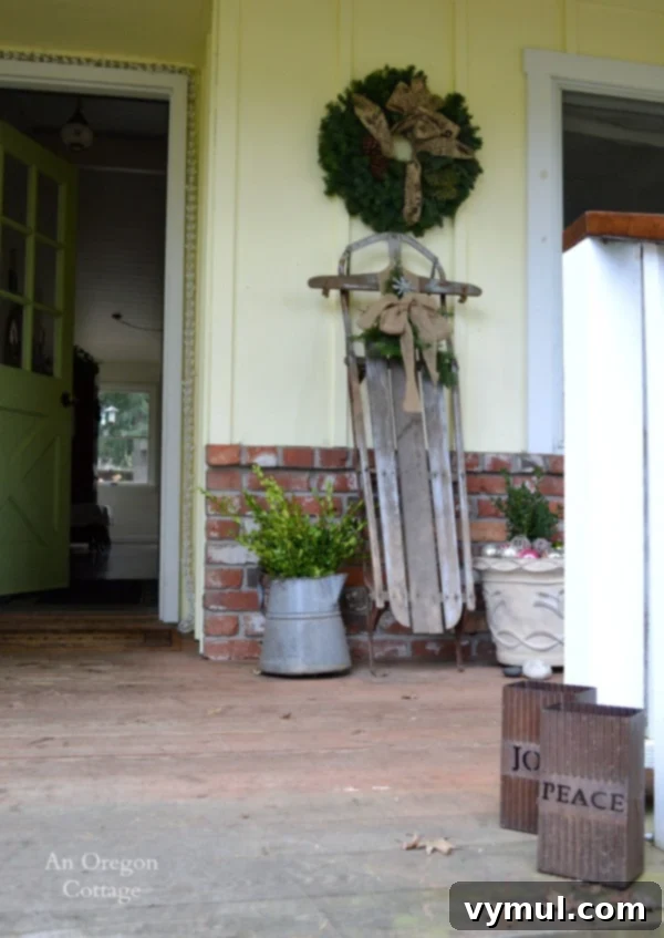 A Cozy Cottage Christmas 2014 3 Simple and inviting cottage Christmas front door decor with greenery and a rustic touch