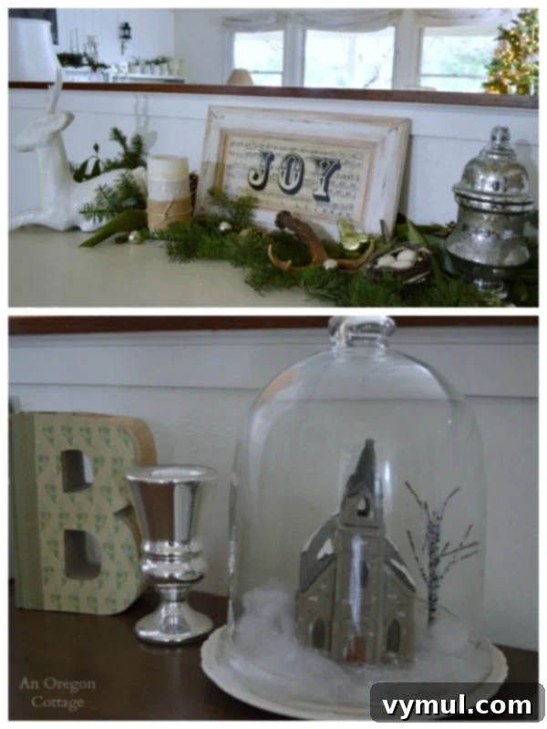 A Cozy Cottage Christmas 2014 7 Cottage Christmas sideboard featuring a 'JOY' sign, cloche with church, and natural greenery