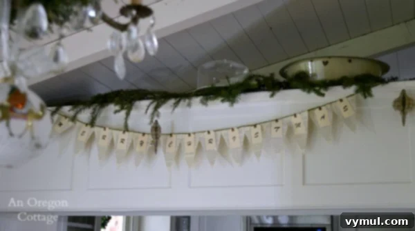 A Cozy Cottage Christmas 2014 8 Merry Christmas book page banner and 3D sheet music ornaments hanging in a cottage kitchen