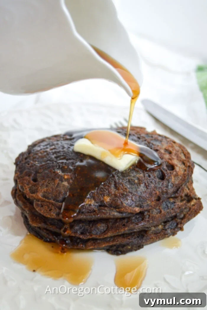 pouring syrup on buckwheat pancakes