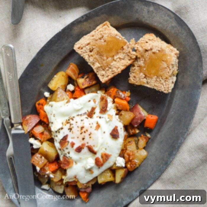 Two plates of roasted root vegetable hash topped with fried eggs, bacon, and feta cheese