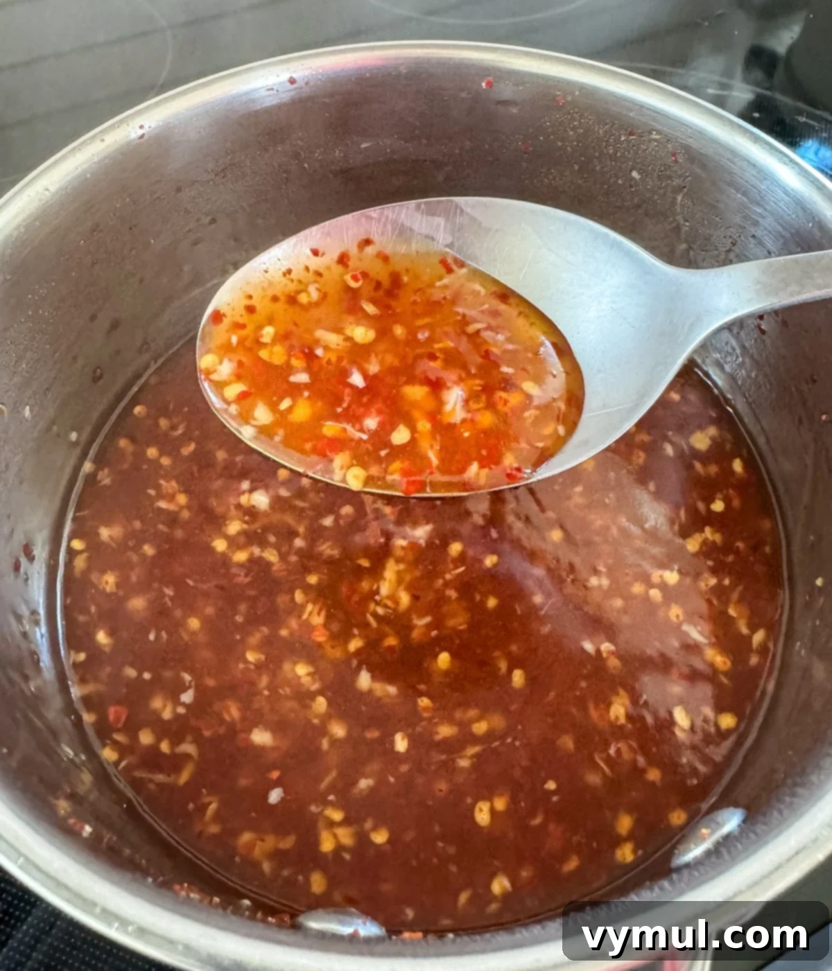 thickened sweet chili sauce on large spoon