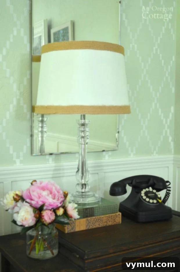 Decorated table vignette set against a newly DIY stenciled wall, creating a stylish backdrop
