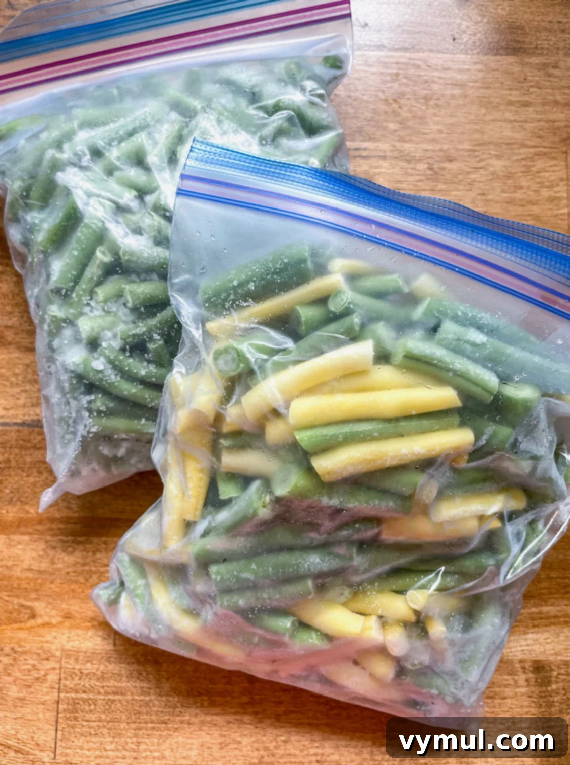 Garden-Fresh All Year: 36+ Ways to Preserve Vegetables by Freezing, Drying, Canning, and Fermenting 3 two bags of frozen green beans on wood counter