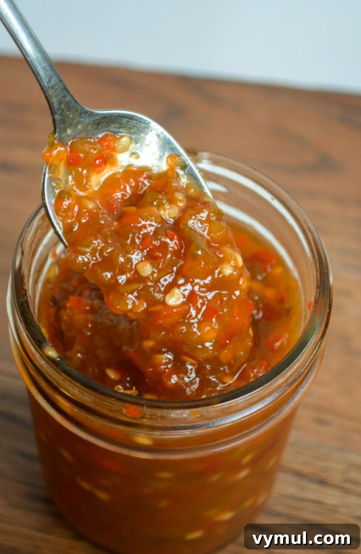 Garden-Fresh All Year: 36+ Ways to Preserve Vegetables by Freezing, Drying, Canning, and Fermenting 24 spooning out jalapeno jelly from a jar
