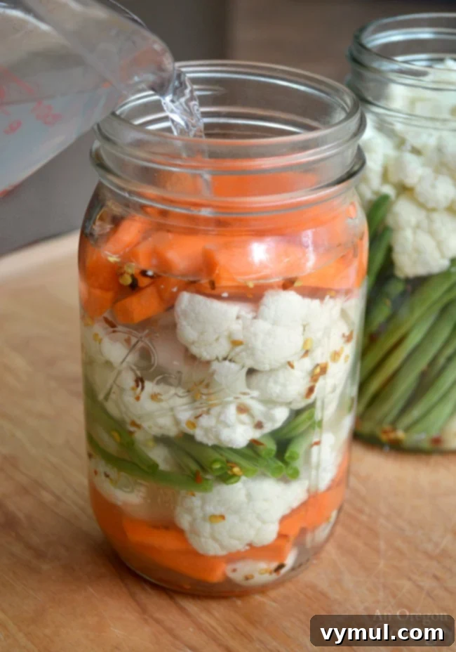 Garden-Fresh All Year: 36+ Ways to Preserve Vegetables by Freezing, Drying, Canning, and Fermenting 28 Fermented pickled vegetables-pouring salt water