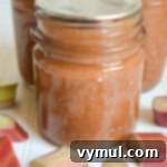 Close up shot of a sealed jar of homemade honey rhubarb ginger jam