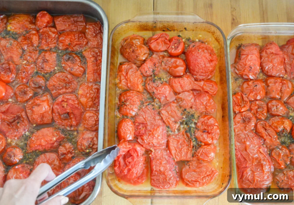Home Canned Roasted Tomato Sauce 5 using tongs to remove peels on pans of roasted tomatoes