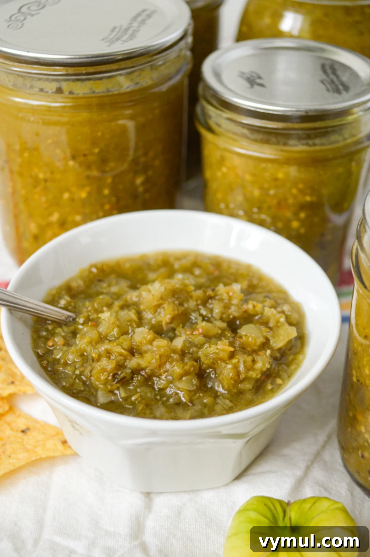 Simple Roasted Salsa Verde: Tomatillo & Green Tomato (Batch & Preserve) 2 salsa verde recipe in white bowl with canned jars behind