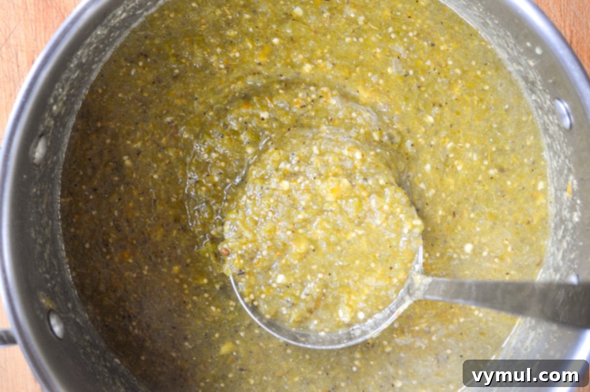 Simple Roasted Salsa Verde: Tomatillo & Green Tomato (Batch & Preserve) 6 cooking salsa verde in a pot with a ladle