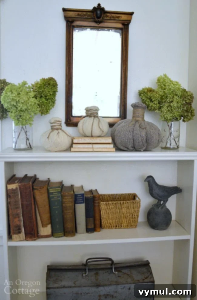 Transform Thrifted Sweaters into Felt Wool Pumpkins 7 Beautiful arrangement of DIY sweater pumpkins made from upcycled felted wool, complementing natural fall gourds