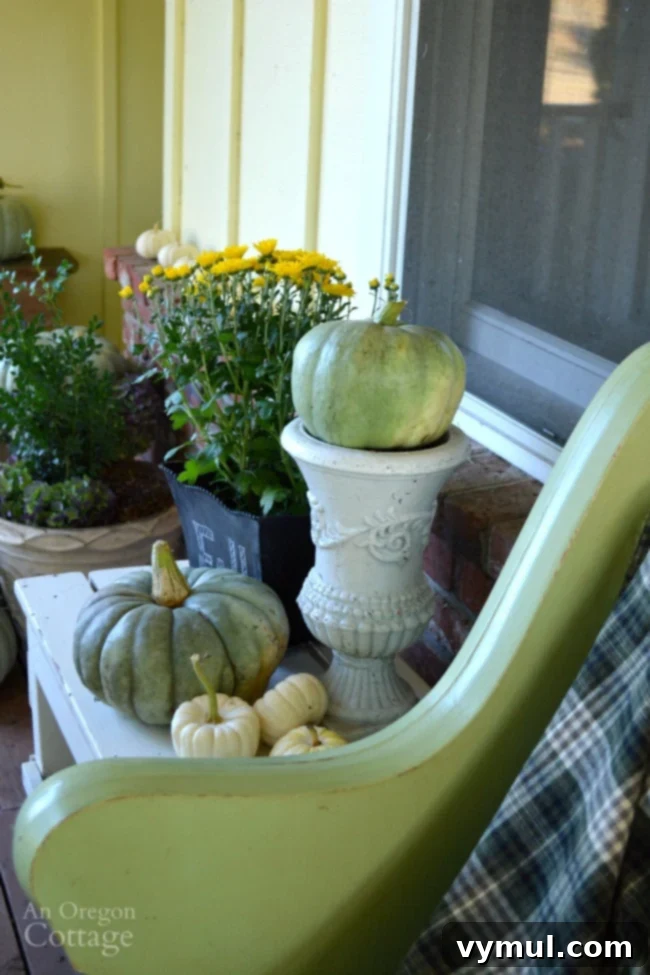Neutral and Natural Fall Porch decor featuring a variety of pumpkins and mums in pots.