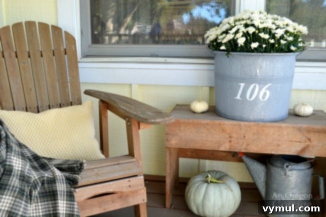 Easy & Simple Fall Porch decorated with pumpkins, mums, and hydrangeas.