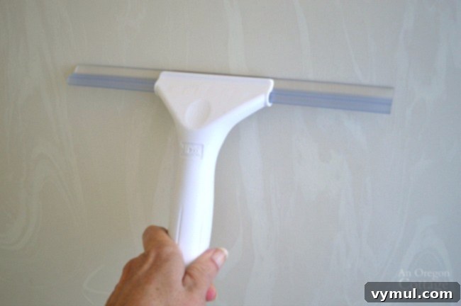 Sustainable Sparkle: Green Cleaning for Your Bathroom 5 A squeegee works to clean smooth shower walls