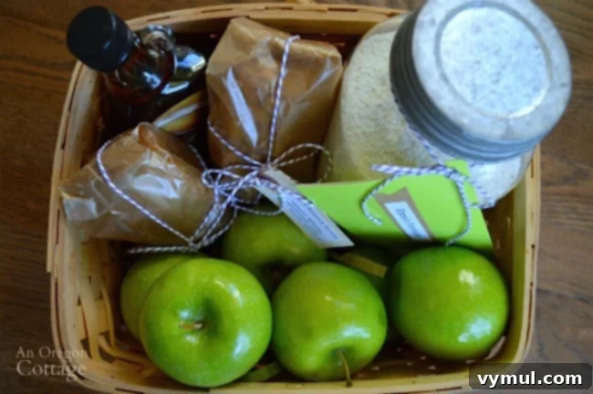 A close-up of a real food breakfast gift basket, showcasing homemade quick bread, a jar of pancake mix, and fresh green apples.